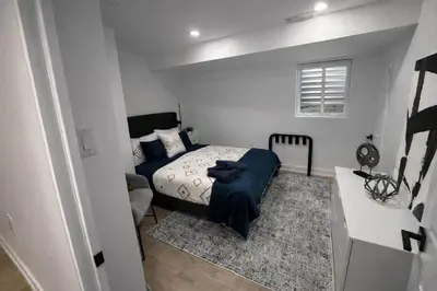 a small bedroom with a bed and a couch at 2 Bed Newly Renovated unit near Falls and Buffalo in Port Colborne