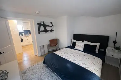 a bedroom with a bed and a chair in it at 2 Bed Newly Renovated unit near Falls and Buffalo in Port Colborne