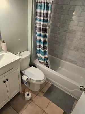 a bathroom with a toilet and a sink and a tub at Central Signature Stay Downtown-Direct Transit to BMO Field Union & Free Wifi in Toronto
