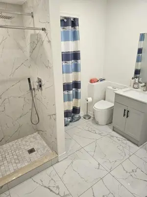 a bathroom with a shower and a toilet at Central Signature Stay Downtown-Direct Transit to BMO Field Union & Free Wifi in Toronto