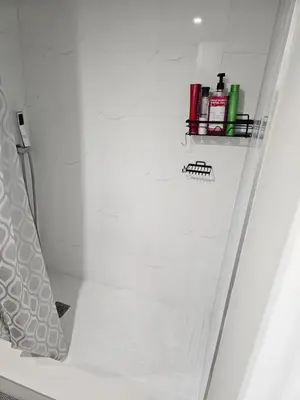 a bathroom with a shower with a shelf on the wall at Central Signature Stay Downtown-Direct Transit to BMO Field Union & Free Wifi in Toronto