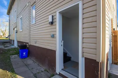 an open door into a garage on a house at Stylish 3BR Steps to Canal, Easy Drive to Falls in Port Colborne