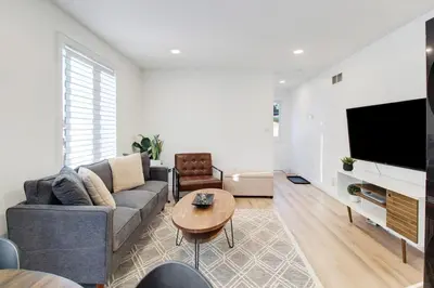 a living room with a couch and a table at Stylish 3BR Steps to Canal, Easy Drive to Falls in Port Colborne