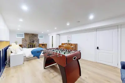 a bedroom with a bed and a foosball table at Lux 7 Bedroom Home [Near Rogers Stadium/Downsview] in Toronto
