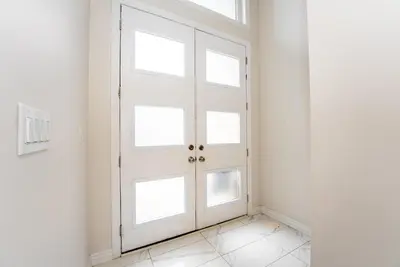 a white door with windows in a white room at Modern Vaughan Retreat, 10 mins to Pearson Airport, Vaughan Mall in Vaughan