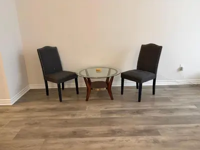 two chairs and a glass table in a room at Modern Vaughan Retreat, 10 mins to Pearson Airport, Vaughan Mall in Vaughan