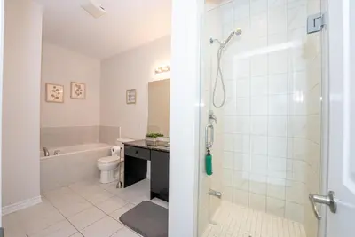 a bathroom with a shower and a toilet and a sink at Modern Vaughan Retreat, 10 mins to Pearson Airport, Vaughan Mall in Vaughan