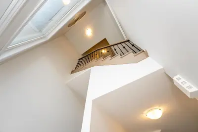 a staircase in a house with a ceiling at Modern Vaughan Retreat, 10 mins to Pearson Airport, Vaughan Mall in Vaughan