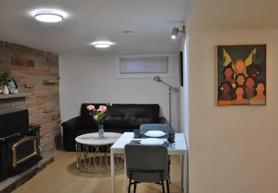 a living room with a table and a couch at Cozy Private Room with Shared Bathroom in Toronto in Toronto