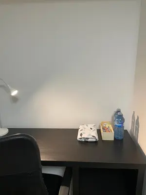 a desk with a bottle of water and a towel at Cozy Private Room with Shared Bathroom in Toronto in Toronto