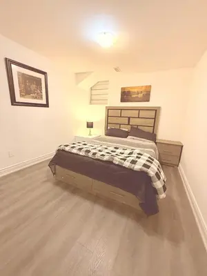 a bedroom with a large bed in a room at Cedar Hedge Private Basement Apartment in Milton