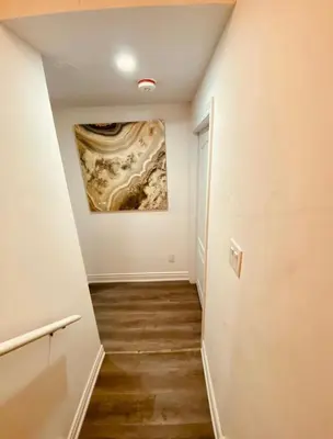a hallway with a painting on the wall at Cedar Hedge Private Basement Apartment in Milton