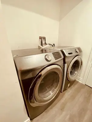 a stainless steel washing machine in a room at Cedar Hedge Private Basement Apartment in Milton