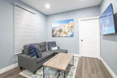 a living room with a couch and a table at Designer 2BR Suite - Steps to Vic Hospital - Wortley in London