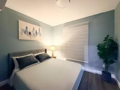 a bedroom with a large white bed and a window at Designer 2BR Suite - Steps to Vic Hospital - Wortley in London