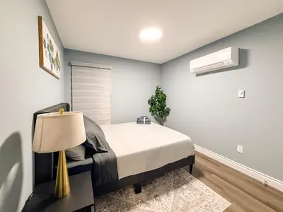 a bedroom with a bed and a lamp at Designer 2BR Suite - Steps to Vic Hospital - Wortley in London