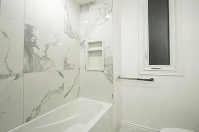 a white bathroom with a tub and a sink at Designer 2BR Suite - Steps to Vic Hospital - Wortley in London