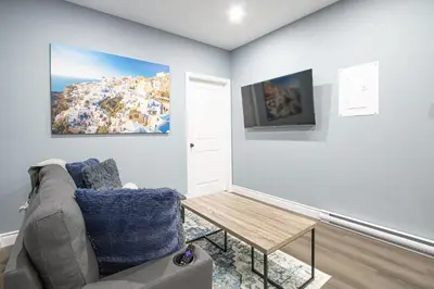 a living room with a couch and a table at Designer 2BR Suite - Steps to Vic Hospital - Wortley in London