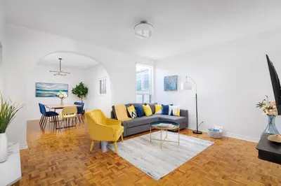 a living room with a couch and a table at Charming 4 Bed Home + 2Parking in Toronto