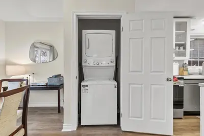 a white refrigerator in a kitchen next to a door at Chelsea Suite 3BR, 1B with parking for 28plus stays in St. Catharines