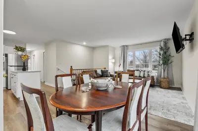 a kitchen and dining room with a table and chairs at Chelsea Suite 3BR, 1B with parking for 28plus stays in St. Catharines