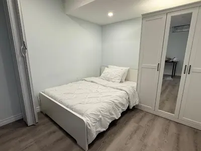 a small bedroom with a bed and a closet at Modern Luxury Private Suite with Parking - Mississauga in Mississauga
