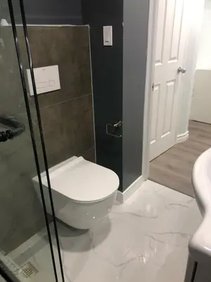 a bathroom with a toilet and a glass shower at Modern Luxury Private Suite with Parking - Mississauga in Mississauga