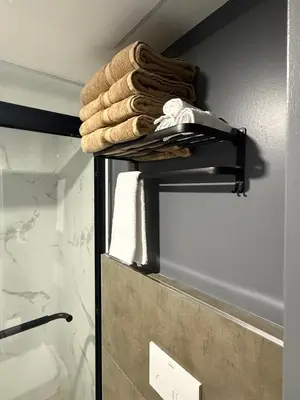a pile of towels on a shelf in a bathroom at Modern Luxury Private Suite with Parking - Mississauga in Mississauga