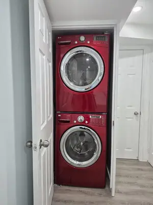 a red washer and dryer in a room at Modern Luxury Private Suite with Parking - Mississauga in Mississauga