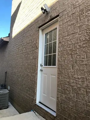 a white door on the side of a brick building at Modern Luxury Private Suite with Parking - Mississauga in Mississauga