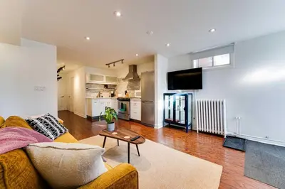 a living room with a couch and a table at Contemporary 1BR Basement Suite with Private Entrance in Toronto