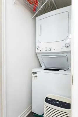 a washer and dryer in a laundry room at Contemporary 1BR Basement Suite with Private Entrance in Toronto