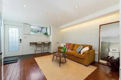a living room with a couch and a table at Contemporary 1BR Basement Suite with Private Entrance in Toronto