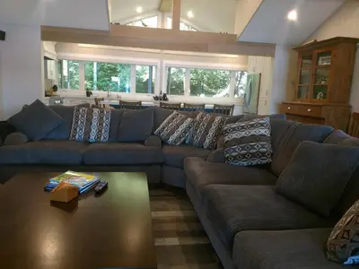 a living room with a couch and a coffee table at Olga's Bay Lakehouse in Minett