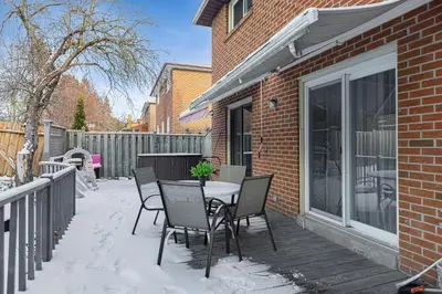 a table and chairs on a deck with snow on it at 166 Main - Family Getaway 5BR Home with Backyard & Parking in Markham