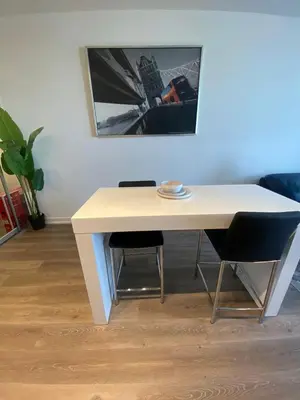 a white table with two chairs in a room at Luxury 2 Bed Apartment In Vaughan Near Wonderland! in Vaughan