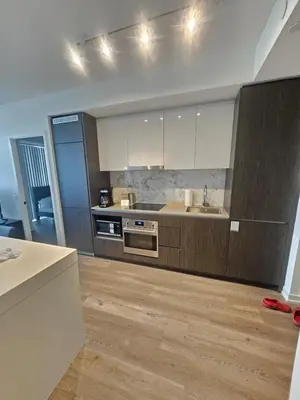 a kitchen with a sink and a stove at Luxury 2 Bed Apartment In Vaughan Near Wonderland! in Vaughan
