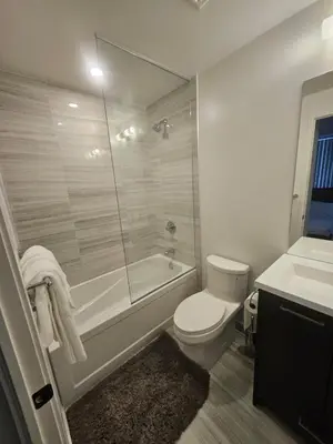 a bathroom with a shower and a toilet and a sink at Luxury 2 Bed Apartment In Vaughan Near Wonderland! in Vaughan