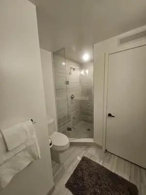 a bathroom with a toilet and a glass shower at Luxury 2 Bed Apartment In Vaughan Near Wonderland! in Vaughan
