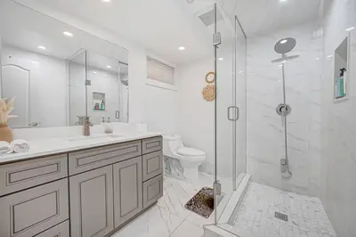 a bathroom with a shower and a sink and a toilet at 166 Basement - Cozy 3BR Markham Stay, Patio, Parking, Pet-Free in Markham