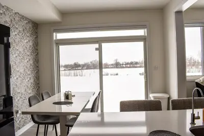 a dining room with a table and chairs and a window at Spacious 4BR Home with EV Charger in Cambridge