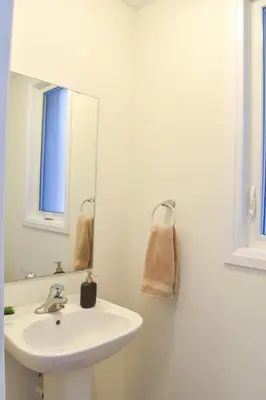 a bathroom with a sink and a mirror at Spacious 4BR Home with EV Charger in Cambridge