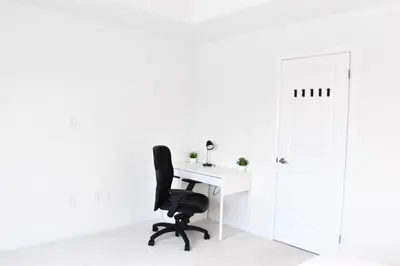 an office with a white desk and a black chair at Spacious 4BR Home with EV Charger in Cambridge