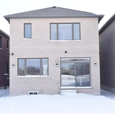 a brick building with windows and a door at Spacious 4BR Home with EV Charger in Cambridge