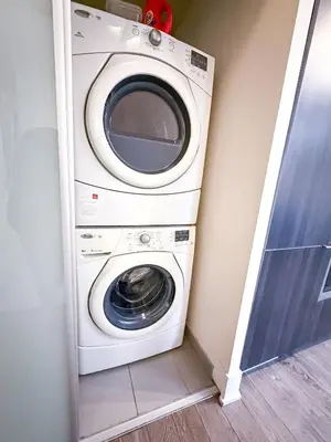 a washer and dryer in a corner of a room at CityPlace Lofts Free Parking in Toronto