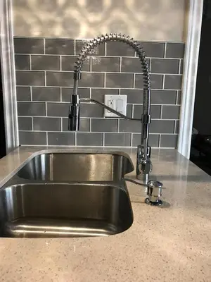 a stainless steel kitchen sink with a faucet at Warm Stylish 4 Bedroom Home 3 Bath in Ajax