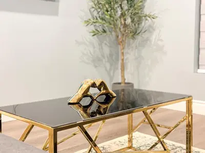 a glass table with a pair of gold shoes on it at Quiet, Soundproof 1-BR Suite Near Victoria Hospital with Parking & Balcony in London