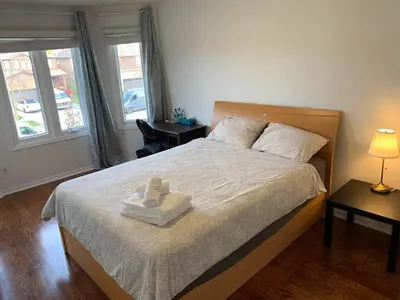 a bedroom with a bed with a towel on it at Private Bright cozy bedroom in Mississauga
