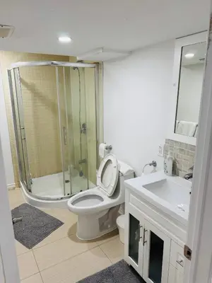 a bathroom with a shower and a toilet and a sink at Private Deluxe basement suiteP1 in Mississauga