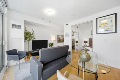 a living room with a couch and a glass table at Downtown Toronto CN Tower Condo in Toronto